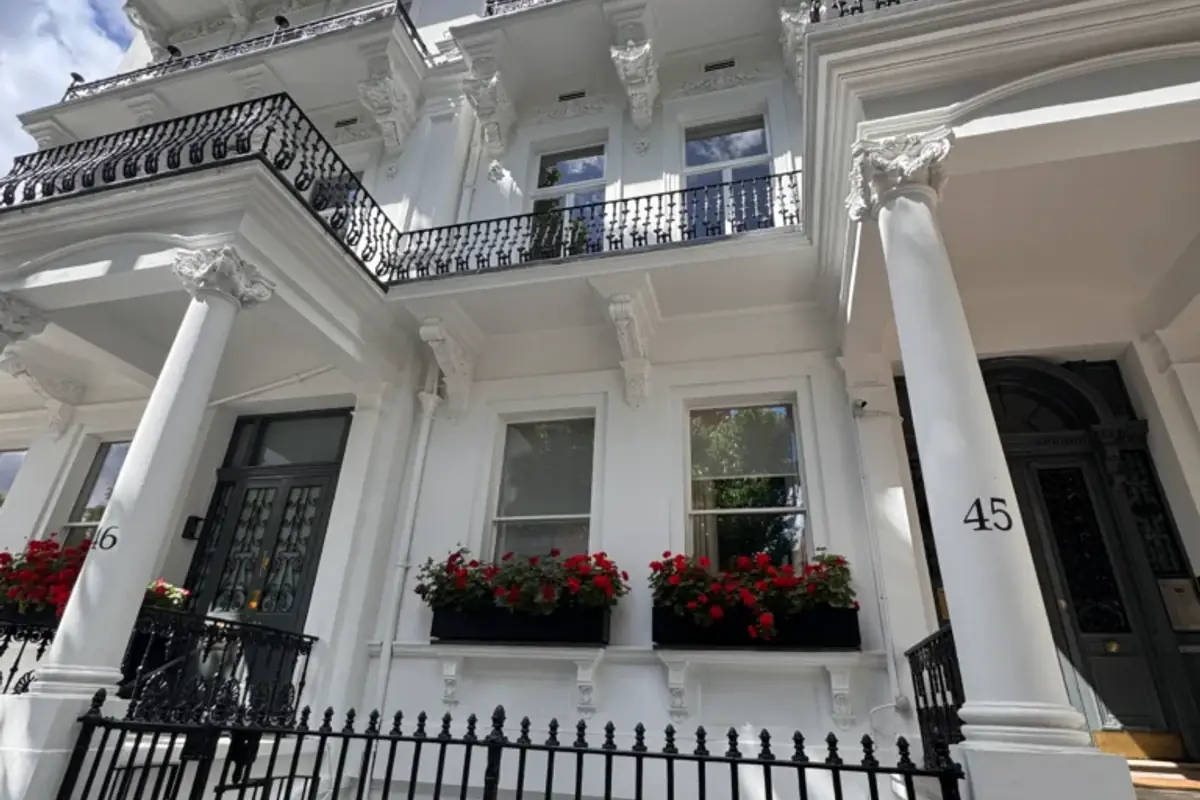 White stucco terrace with ornate balconies and window boxes