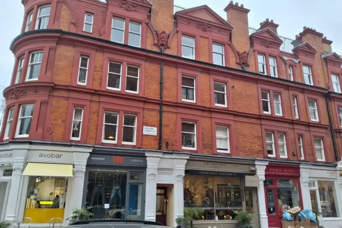 Red brick mansion block above ground floor retail units